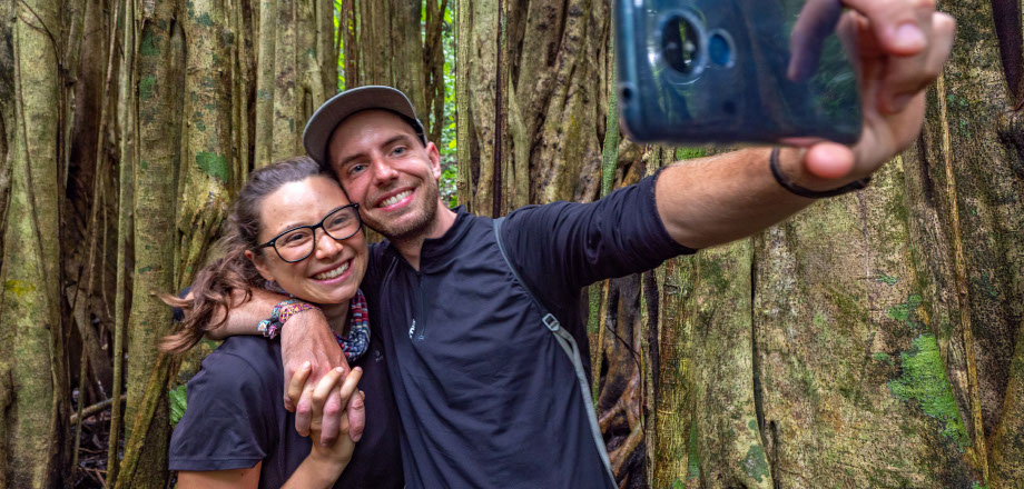 The jungle surrounds a sign pointing eco-tourists to the Ecoturístico La Tarde, Osa Peninsula, Costa Rica.